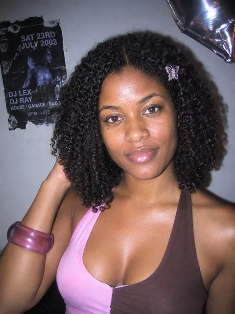 Fictional woman with a butterfly hair clip in a 2003-style flash party snapshot